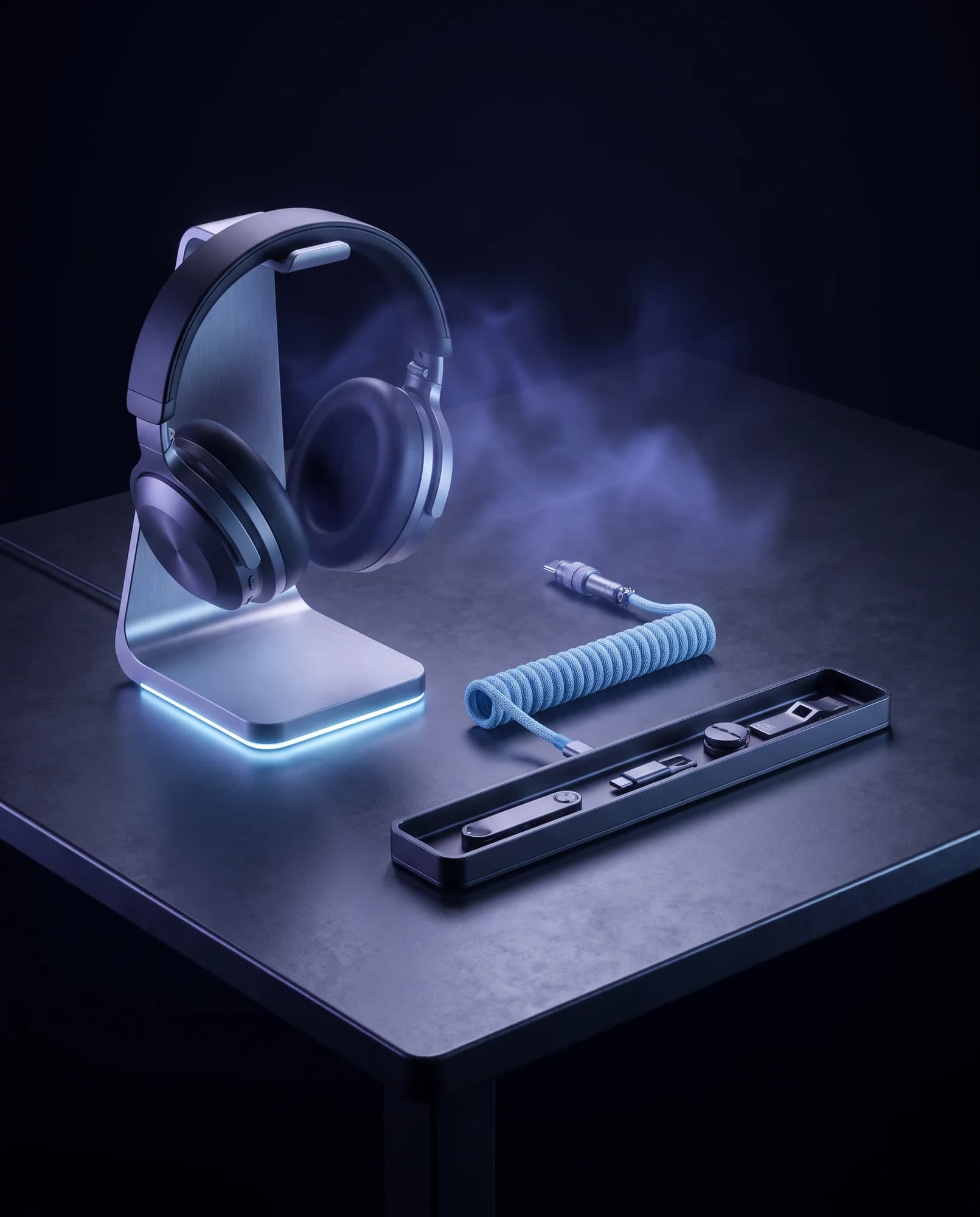 Headphone stand with underglow and a coiled cable on a dark desk