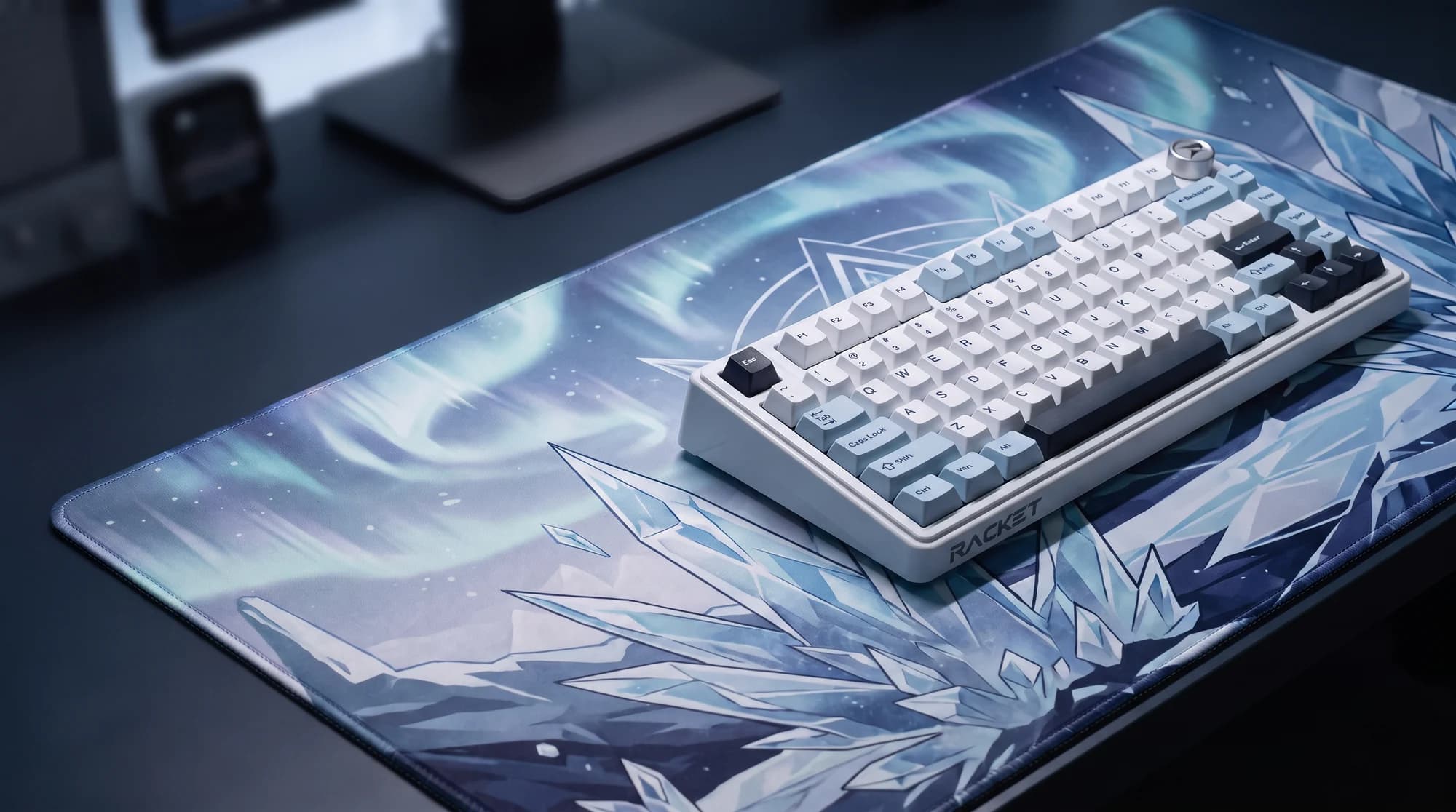 RACKET K75 Glacier Blue on an ice-crystal art desk mat